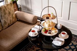 a tray of food on a table in a hotel room at Cameron Highlands Resort - Small Luxury Hotels of the World in Cameron Highlands +21 photos