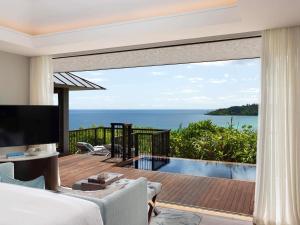 a bedroom in a villa with a view of the ocean at Raffles Seychelles in Baie Sainte Anne +170 photos