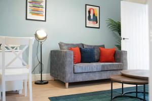 a living room with a gray couch with red pillows at Sunderland 3BR Retreat Sleeps 6 by Stay With Us in Pallion