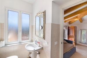a bathroom with a sink and a mirror at Rosa Di Mare Guest House in Finale Ligure