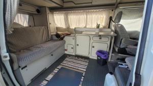 an interior view of an rv with the door open at Sleep inside a classic Volkswagen Westfalia or our legendary Mercedes Düdo overland cabin in central Svolvær Close to public showers and toilets NO PARKING in Svolvær