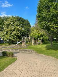 a playground in a park with a tree at Haus Auf Bulz - Klippeneck in Denkingen