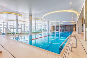 a large swimming pool in a large building at Happy Land Aqua Polanki B407 in Kołobrzeg +26 photos