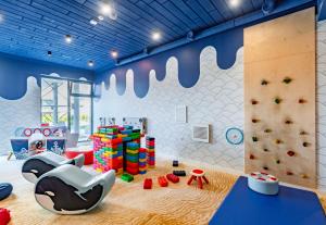 a childrens play room with a rock wall and a climbing wall at Happy Land Aqua Polanki B407 in Kołobrzeg