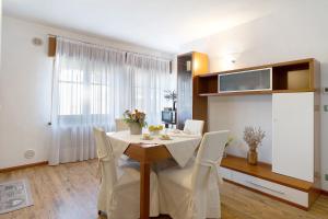 a dining room with a white table and chairs at Alla Loggia dell'Imperatore in Levico Terme