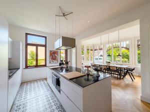 a kitchen with white appliances and a dining room at Villa Boddenwacht in Ahrenshoop