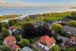 an aerial view of a residential neighborhood with houses and the water at Villa Boddenwacht in Ahrenshoop