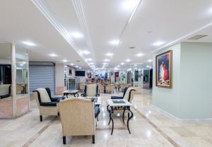 a waiting room with chairs and tables in a building at Senza Sunset Beach Hotel in Alanya