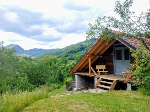 a log cabin with a porch and a bench outside at The hayloft in Grohoţele