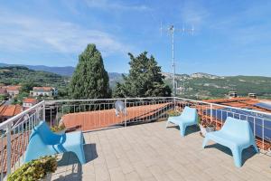 three blue chairs sitting on a balcony with a view at Rosa Di Mare Guest House in Finale Ligure