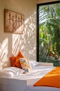 a bed in a room with a large window at Aeraki palms in Bordi +115 photos