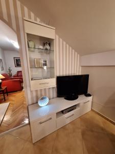 a living room with a television on a white entertainment center at MÐM Duplex Apartment in Podgorica