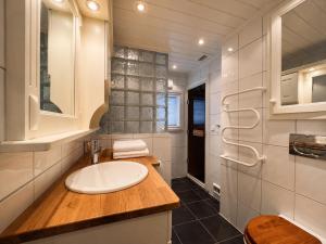 a white bathroom with a sink and a mirror at Large, cozy, and spacious cabin in Geilo, Kikut in Geilo