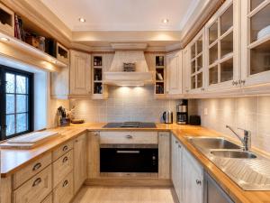 a kitchen with wooden cabinets and a sink at Large, cozy, and spacious cabin in Geilo, Kikut in Geilo +20 photos