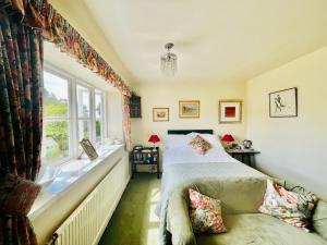 a bedroom with a bed and a window at Garwood House in Holt
