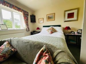 a bedroom with a bed and a window at Garwood House in Holt