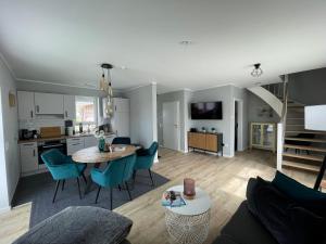 a living room and kitchen with a table and chairs at Wangerstrand in Wangerland