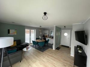 a living room with a couch and a table at Wangerstrand in Wangerland