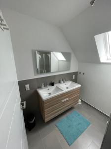 a bathroom with a sink and a mirror at Wangerstrand in Wangerland +13 photos