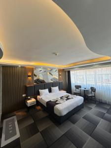 a bedroom with a large bed and a table at Lizbonia Suit Otel in Istanbul +32 photos