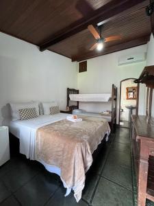 a bedroom with a large bed in a room at Pousada Marendaz in Paraty