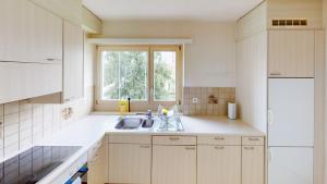 a kitchen with a sink and a window at Charming 3 Bedroom Retreat in Zurich