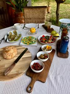 a table topped with plates and bowls of food at Cefalù Forest Hideout in Cefalù