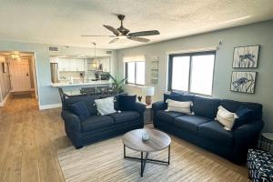 a living room with a blue couch and a table at Reef Club 401 in Clearwater Beach