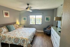a bedroom with a bed and a window at Reef Club 401 in Clearwater Beach