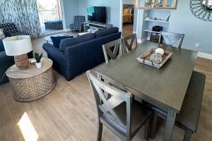 a living room with a table and a couch at Reef Club 401 in Clearwater Beach +41 photos