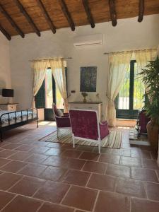 a living room with a table and chairs and windows at Palacio de Montellano in Montellano