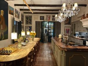 a kitchen with a long table with chessetts on it at Palacio de Montellano in Montellano