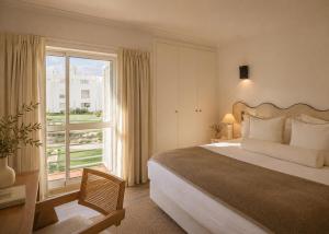 a bedroom with a large bed and a large window at Masana Algarve, Destination by Hyatt in Albufeira +66 photos
