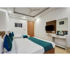 a bedroom with two beds and a television at Family Group with Provide By PG Hotel Near New Delhi Railway station & Karol-Bagh in New Delhi