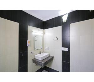 a bathroom with a sink and a mirror at Family Group with Provide By PG Hotel Near New Delhi Railway station & Karol-Bagh in New Delhi