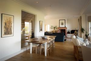 a kitchen and living room with a wooden table at Farmhouse with Loch Views in Gartocharn