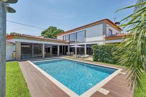 a house with a swimming pool in front of it at Casa de Férias Da Padroa in Braga