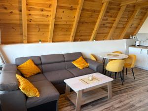 a living room with a couch and a table at Maple Valley in Žabljak