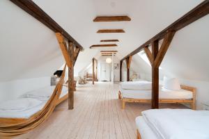 a bedroom with two beds and a room with wooden beams at Ferienhaus Stranden Westfehmarn in Fehmarn
