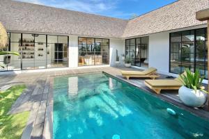 a swimming pool in the backyard of a house at The Young Villas - Canggu in Canggu