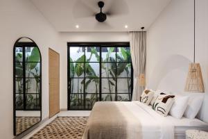 a bedroom with a bed and a large window at The Young Villas - Canggu in Canggu +109 photos