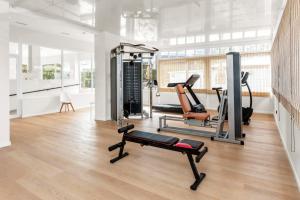 a gym with two treadmills and a treadmill at HSM Lago Park in Playa de Muro