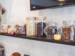 a shelf filled with jars of food on a wall at Mercure Belfort Centre in Belfort