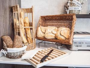 a basket of bread sitting on a shelf next to a printer at Mercure Belfort Centre in Belfort +108 photos