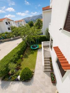 a view of a garden from the balcony of a house at Apartments Mohar II in Baška