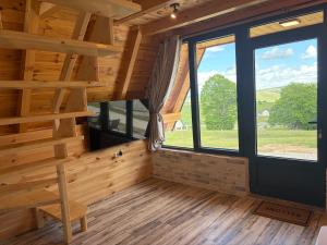 a log cabin with a staircase and a large window at Maple Valley in Žabljak