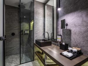 a bathroom with a sink and a shower at Pullman Tbilisi Axis Towers in Tbilisi City +144 photos