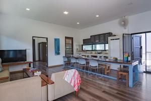 a living room with a couch and a kitchen at Sam Lanta in Ko Lanta