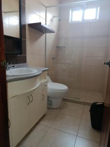 a bathroom with a sink and a toilet at Marina Breeze hotel in Manta