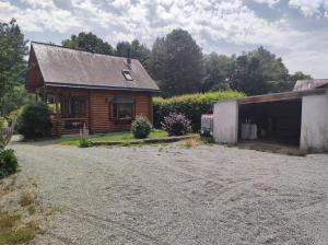 a small house with a garage next to a driveway at Bridget's Home in Lizio +7 photos